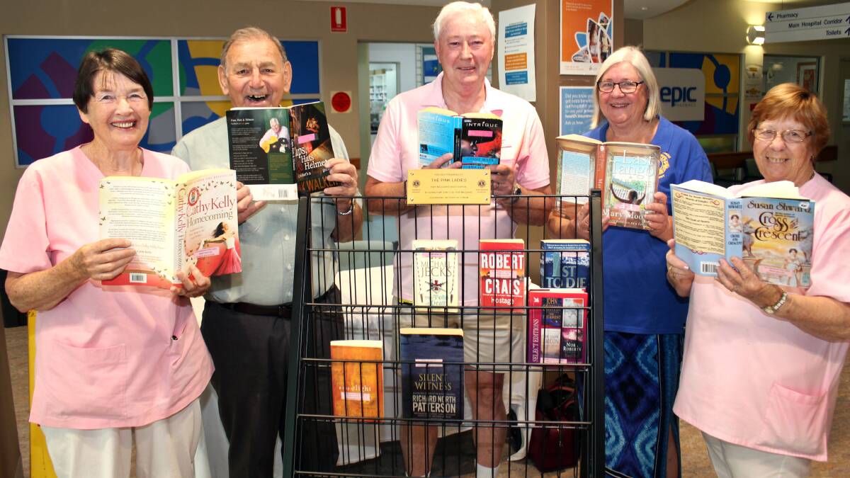 Dorothy Burr, David Butterfield and Lesley Watts of the Port Macquarie Pink Ladies with their latest bookcase donated by Tacking Point Lions Club’s Past President Stuart Aston and Secretary Kathy Moonen.