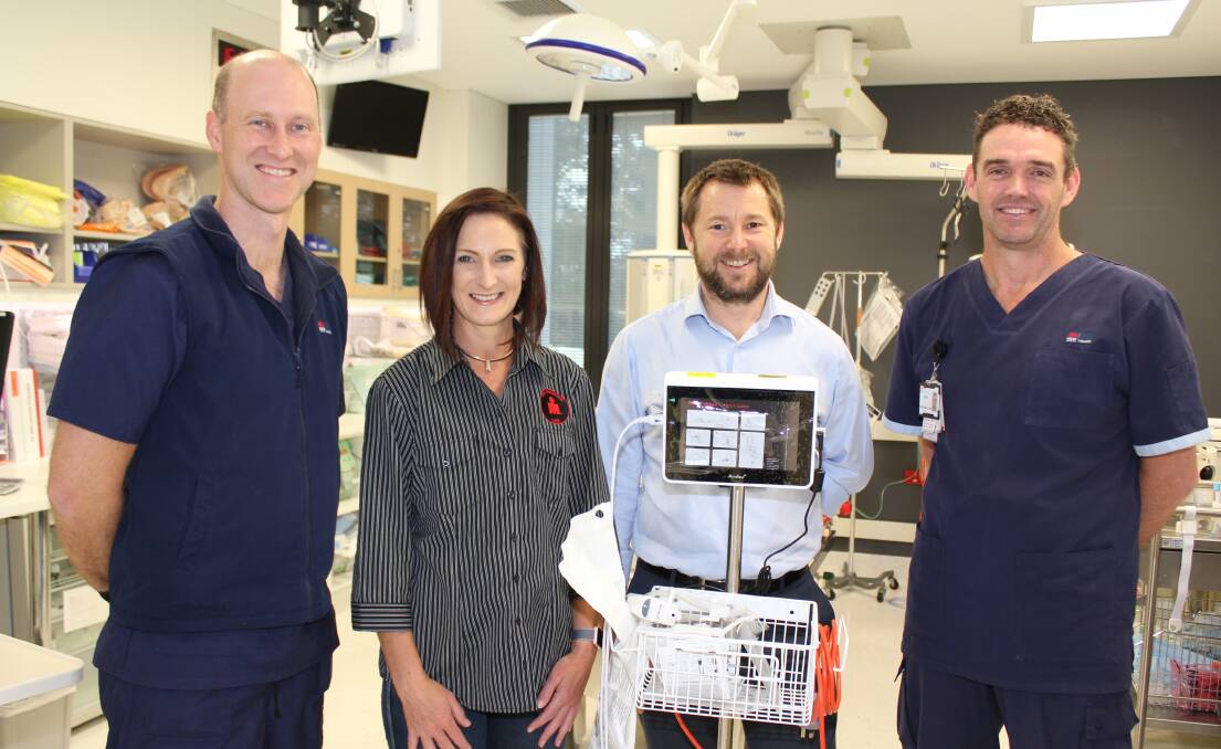 Ironman’s Recovery Services Director Vanessa Grey  presents the bronchoscope to (from left) Emergency Department Acting Nurse Unit Manager Andrew Baxter, Network Director of Emergency Services Alan Forrester and Nurse Simon Ross.