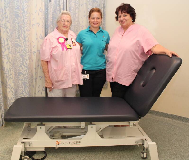 Senior Orthopaedic Physiotherapist Zoe Rowlandson and Fracture Clinic volunteers Hilda Phillips and Jenny Dawson with one of the new height adjustable beds donated by Port Macquarie Pink Ladies.