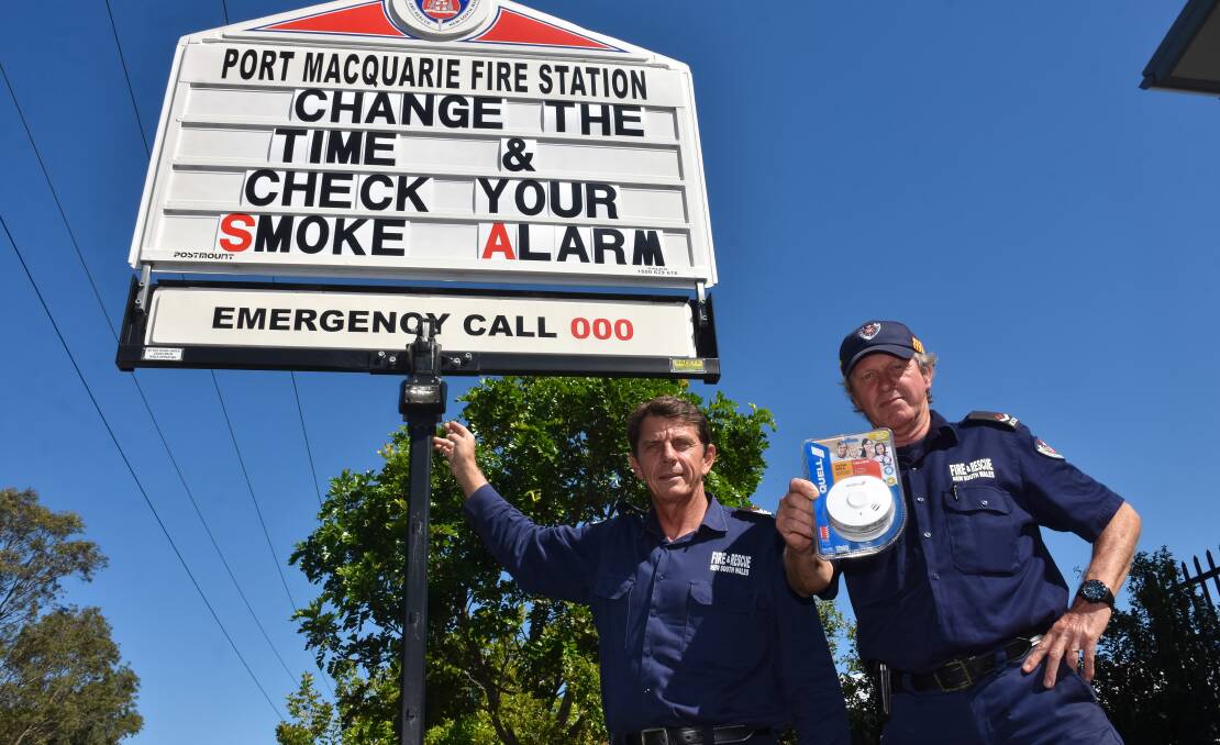 Time for change: Firefighters Adam Scott-Young and David Fell urge Hastings residents to check their smoke alarms this weekend. Photo: Rodney Cooper