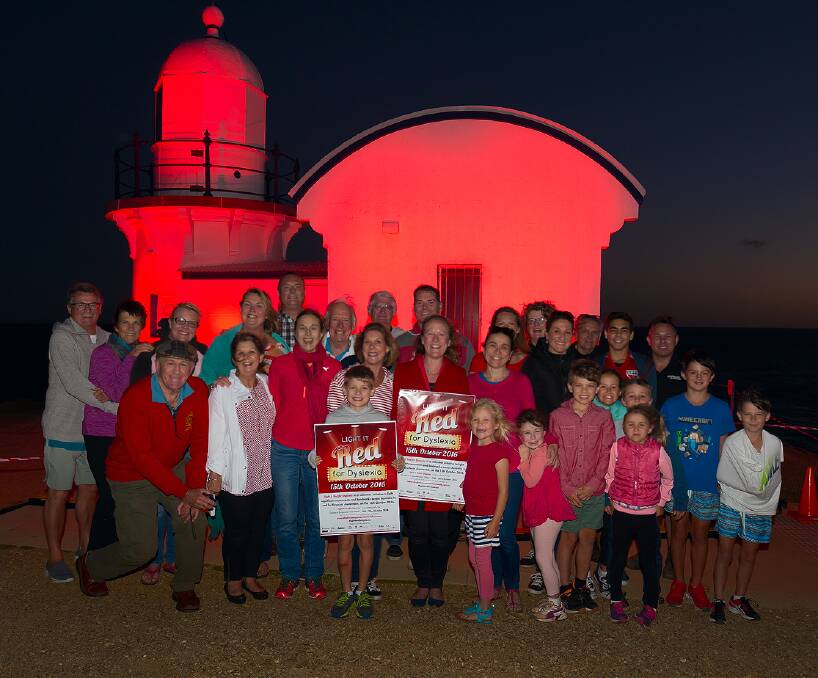 Light up: Tacking Point lighthouse shone red on Saturday night to raise awareness across the Hastings about dyslexia.