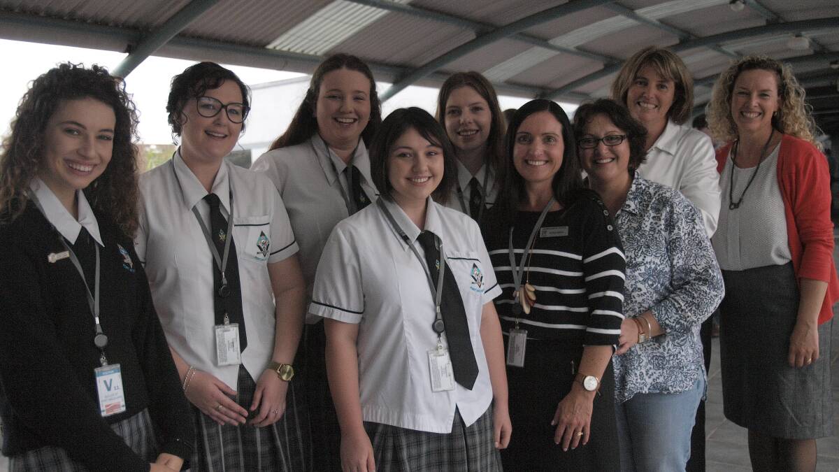  MacKillop College students Diana Smith, Courtney Irwin, McKenzie Kirby-Brown, Ellie Kable, Lauren Judge and teacher Nicole Bailey (front centre) with Essential Energy employees Sally Kay, Lara Rich and Tane Power at one of the fundraising barbecues.