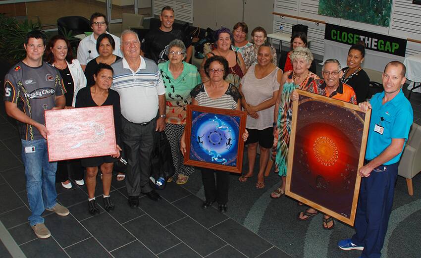 Members of the MNCLHD Physiotherapy, Aboriginal Health and Health Promotion teams with participants of the first Bathu Marrung hydrotherapy program. The three artworks pictured, created by Uncle Morrie Pollock (front row, second from right), were purchase by the MNCLHD Health Promotion team for display at the Port Macquarie Base Hospital.