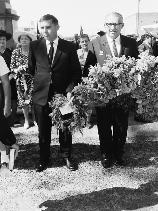 Lieutenant Ross Keena (home on leave following wounds he sustained in Vietnam) and Alderman Les Crisp prepare to lay wreaths, 1967