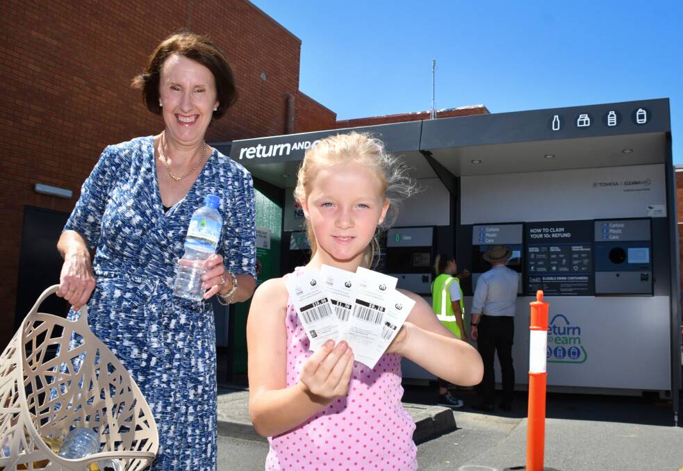 Handy location: Port Macquarie MP Leslie Williams and six-year-old Laila Thorburn promote the Return and Earn reverse vending machine. Photo: Ivan Sajko