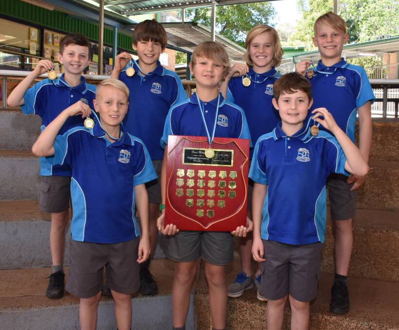 Creative thinkers: NSW Tournament of Minds Champions for Maths and Engineering (back) Sachin Sen Gupta, Sam Kobelke, Finn Hoy, Axel Lindeman, (front) Oliver Barry, Kael Harris and Nicholas Saad display their medals and trophy.