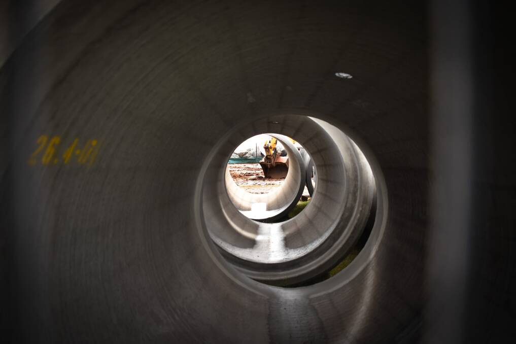 A view to the heavy machinery beyond framed by the pipes. Photo: Ivan Sajko