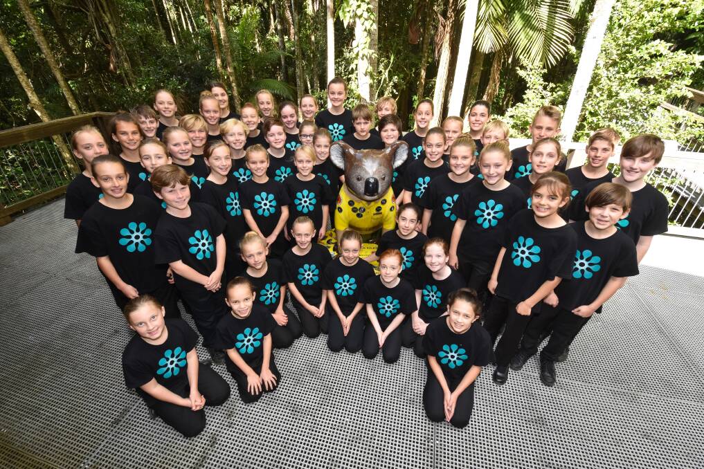 Hitting the right note: Tacking Point Public School's Bel Canto Choir with Ranger Riley, the ambassador for threatened species in NSW National Parks. Photo: Ivan Sajko