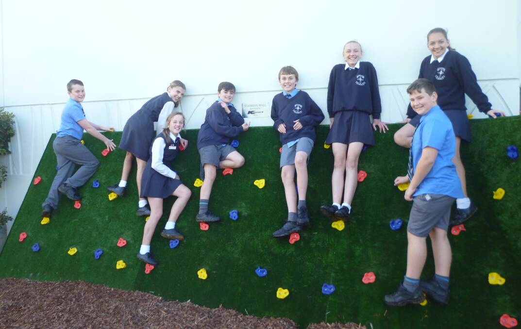 Getting active: St Joseph's Primary School students Jacob Somers, Tia McGrath, Lily Monckton, Ethan Hawkins, Harrison Brown, Jessica Watts, Tenay Bonney and Jett Cherry use the new climbing wall.