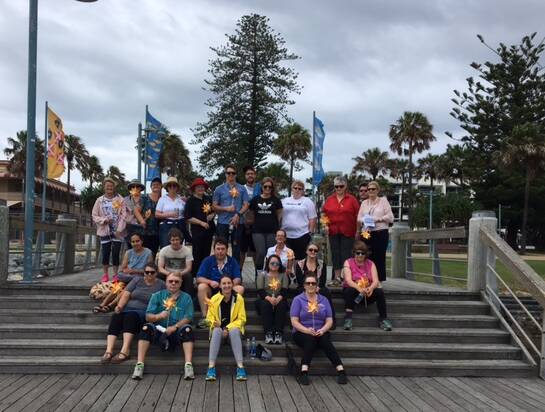 Supporters of the Endeavour Mental Health Recovery Clubhouse Wellness Walk take a break at the Town Green.