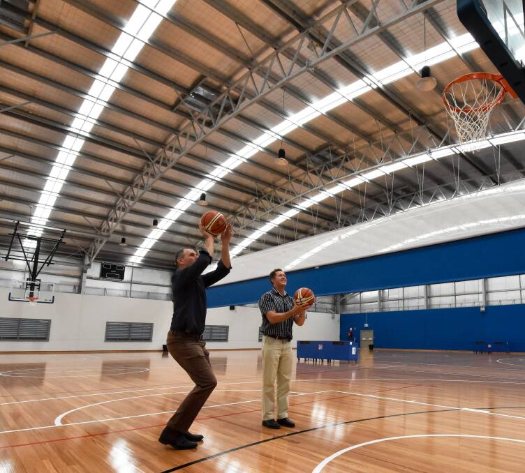 In action: Port Macquarie-Hastings mayor Peter Besseling and Cowper MP Luke Hartsuyker test out the expanded Port Macquarie Indoor Stadium. Photo: Ivan Sajko