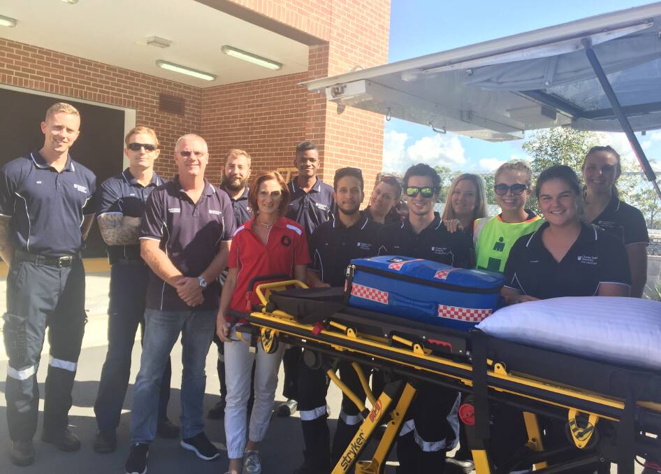 Lecturer Adam Diamond (third from left) with paramedic students Todd Miller, Chris Petrie, Adam Wilson, Ironman Australia Port Macquarie recovery services director Vanessa Gray, and paramedic students Salvadore Wamara, Timothy Sher, Ashleigh Fry, Blake Nelson, Megan Gentz, Chanel Cirillo, Hannah Sanders and Nicole McKellar.
