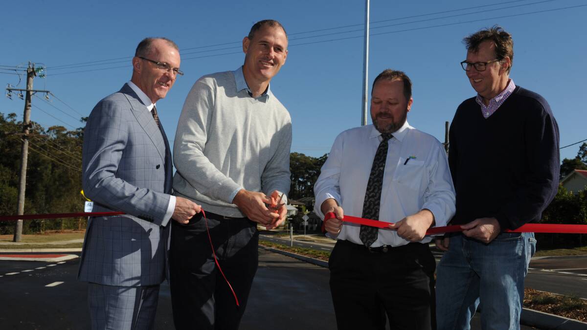 Road project: Cr Justin Levido, mayor Peter Besseling, council director Jeffery Sharp and Cr Rob Turner at the ribbon cutting before the Hastings River Drive stage two upgrade opens to traffic on Thursday afternoon.