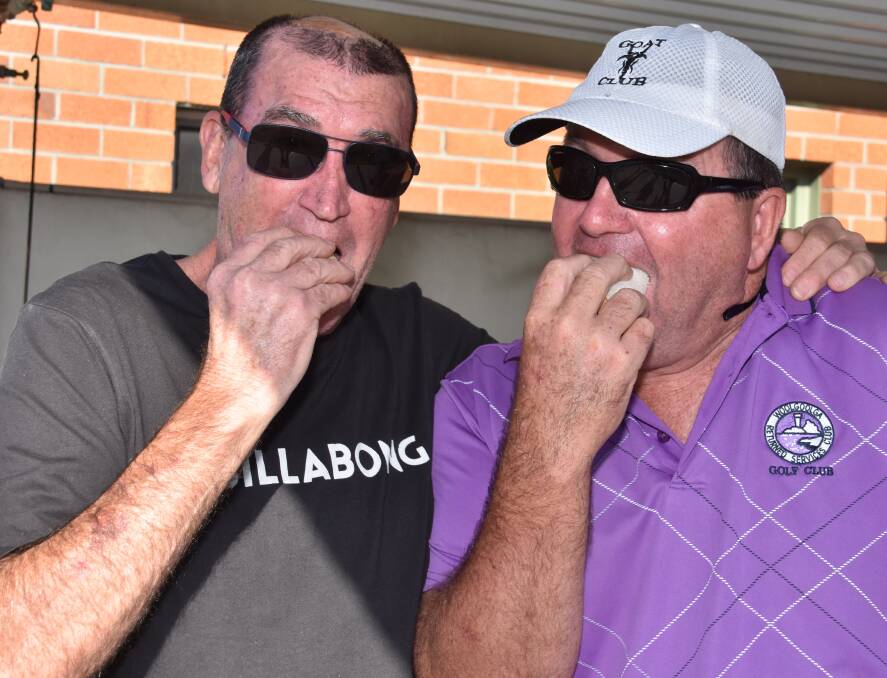 Brad Foster and Graeme Diffey enjoy the food on offer as they relive the 1991 glory days of the Port Macquarie Boardriders.