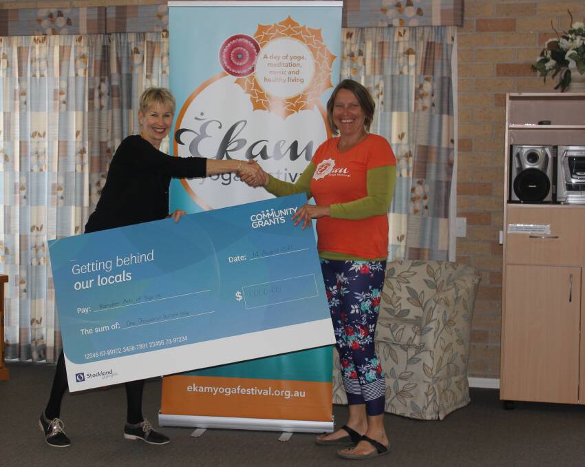 Welcome support: Lincoln Gardens Retirement Village manager Sue Reid presents the cheque on behalf of Stockland Community Grants to Ekam Yoga Festival event manager Denis Juelicher.