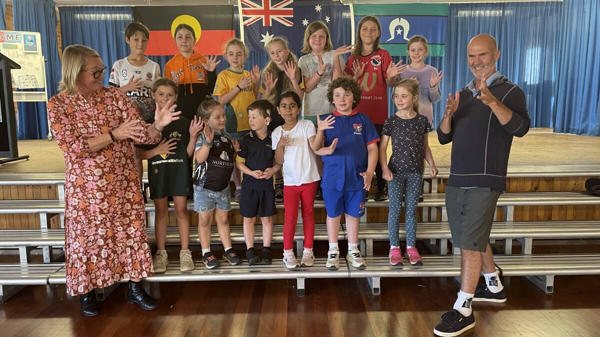 Assistant principal hearing support Kerry Kranitis (left), teacher of the deaf Rodney Adams (right) and Auslan signing choir students at Port Macquarie Public School. Picture by Lisa Tisdell