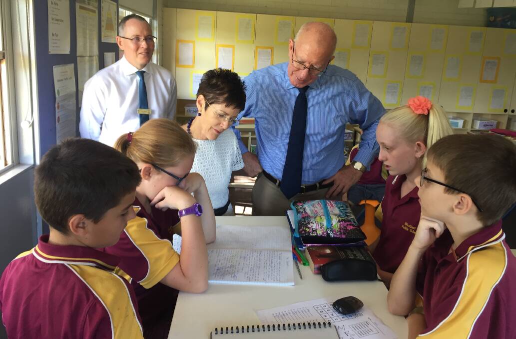 In class: Linda Hurley and NSW Governor David Hurley help Westport Public School students Denver Trudgeon, Hailie Pacey, Savannah Medcalf and Jarrod McKenzie with a lesson as Westport Public School principal Tony Johnston looks on.