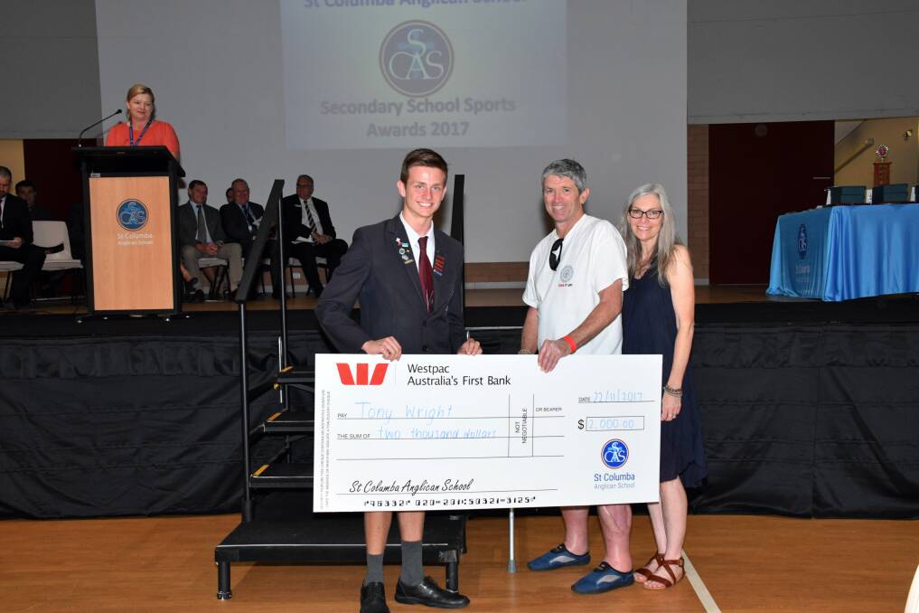 The Interact Club’s vice-president, Jacob Killick, presents the cheque to Tony and Leanne Wright.