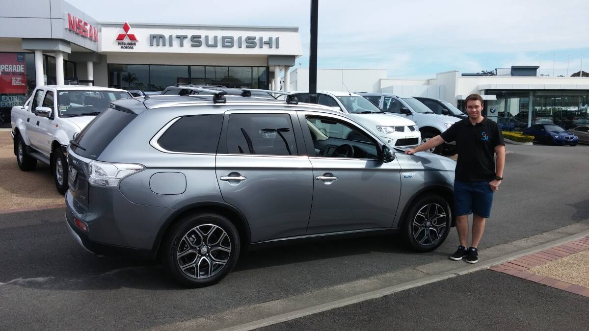 Plug-in and drive: Port Macquarie's Joel Moss with his Mitsubishi Outlander PHEV (Plug-in Hybrid Electric Vehicle).