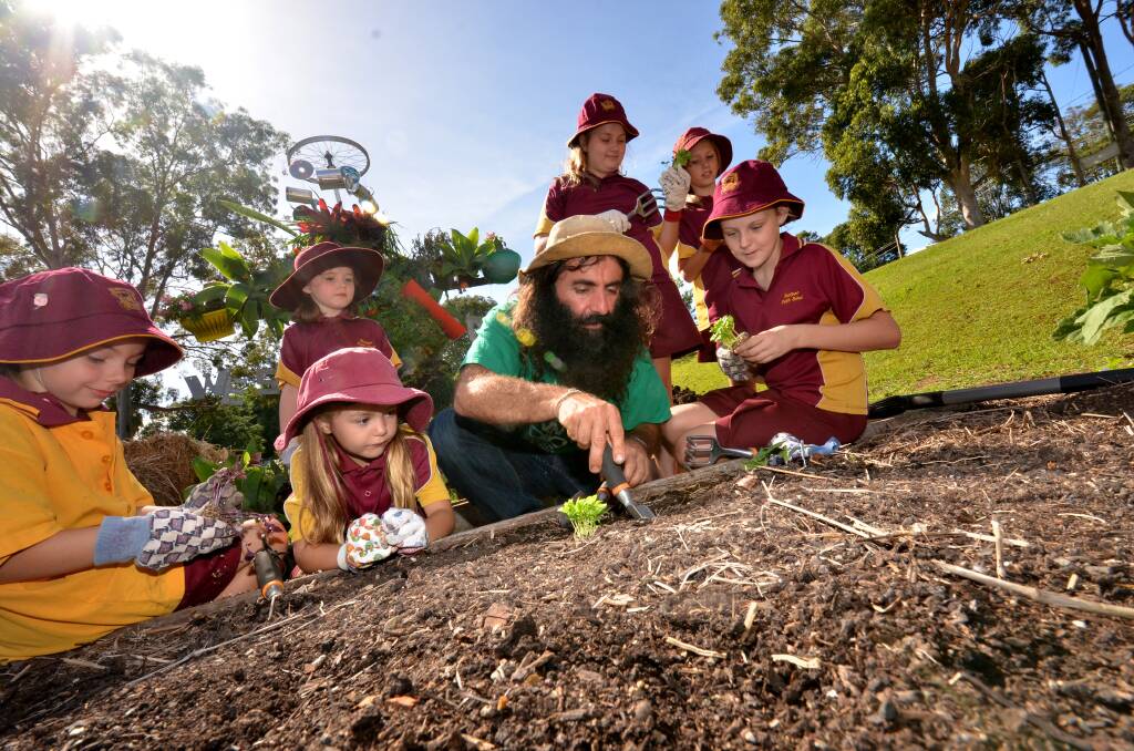 Green thumbs: Gardening Australia host Costa Georgiadis gets to work at the Westport Primary School garden with students Hayley Warren, Livvy Tomlinson, Jorja Freudenstein and (at back) Emily Edenborough, Shantell Sokic and Erikka Connor.