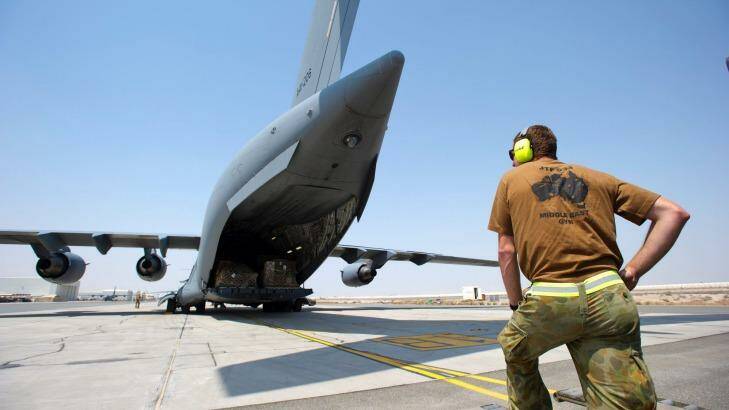 AT WAR? An ADF member prepares to unload a C-17 Globemaster at Al Minhad Air Base. There are inconsistencies around which staff at the base are in "combat roles". Photo: Defence Department
