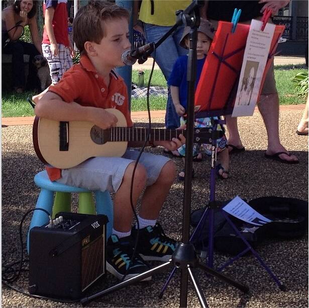 Young talent: Cameron Alford busks on the Town Green to help a sick Victorian boy travel to the FIFA World Cup.