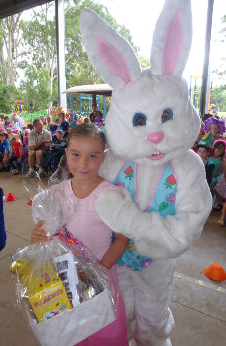 Larger than life: Myah Komene gets a cuddle from the Easter Bunny.