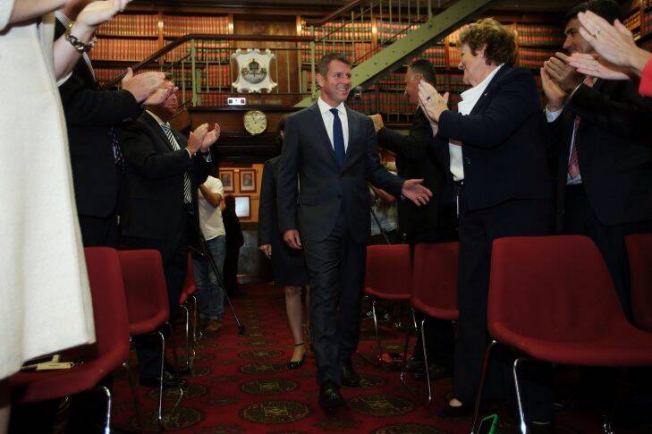 NSW Premier Mike Baird is congratulated as he enters a party room meeting of the NSW Liberal Party where the newly elected MP's were introduced. NSW Parliament, Sydney, NSW. 1st April, 2015. Photo: Kate Geraghty