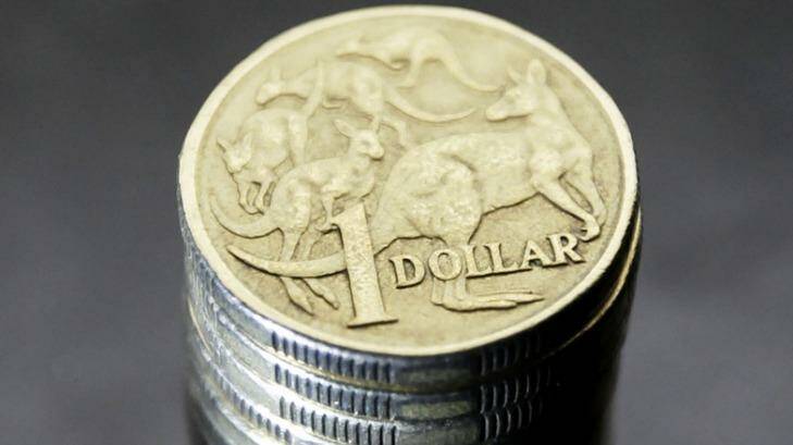 The Australian dollar continues to trade near US72-73¢ but is set to slide by the end of 2015. Photo: Ian Waldie
