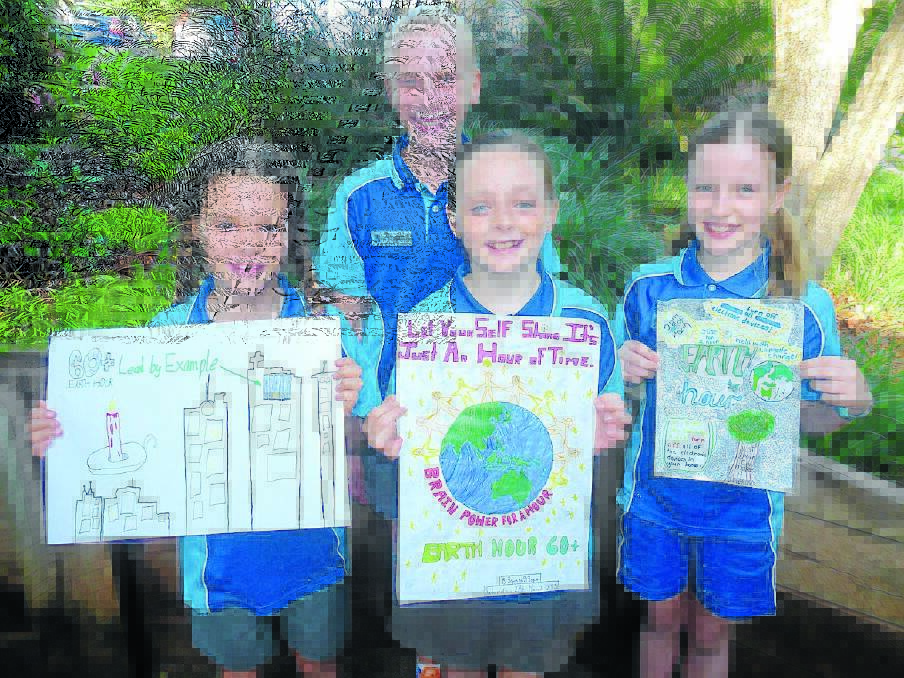 Way to go: Hastings Public School parliamentary environment minister Matilda Lindeman congratulates from left, Amelia Cuckson, Jamison Sawtell and Mirren Campbell on their excellent poster designs for Earth Hour.