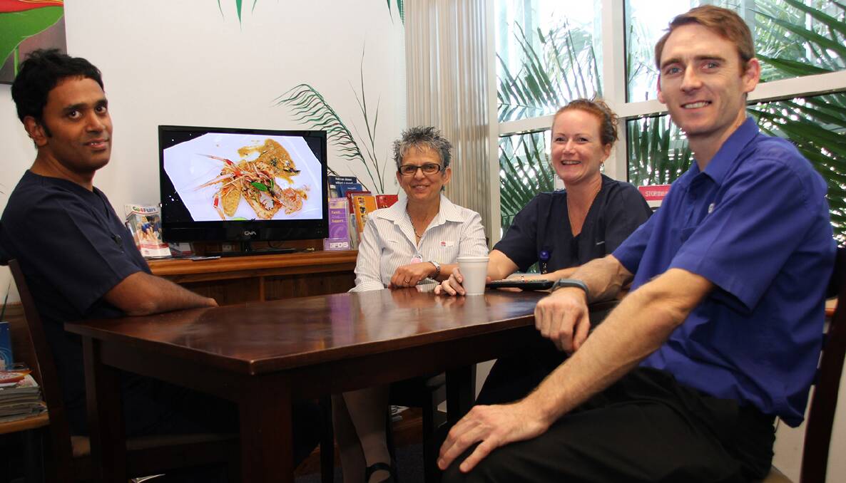 Helping hand: Registered nurse Praveen Joseph, Nursing Unit manager Cheryl Nolte and registered nurse Katie Firkin let The Good Guys Port Macquarie store owner Tony Green know how much his donated TV is appreciated by parents and staff at the Port Macquarie Base Hospital s Paediatric Unit.