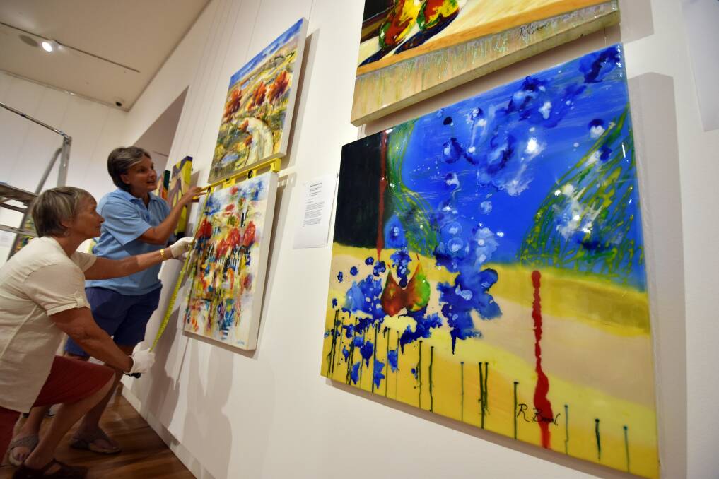 Discover the abstract: Fran Daly and Bernice Daher hang works by the Hastings Valley Fine Arts Association members for their Pathways to Abstraction exhibit at the Glasshouse Regional Gallery.