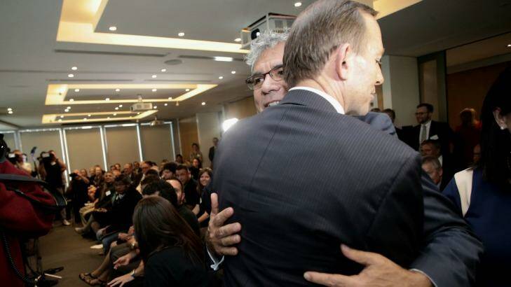 "Defining moment": Tony Abbott embraces Warren Mundine during the Empowered Communities launch in Sydney on Wednesday. Photo: Alex Ellinghausen