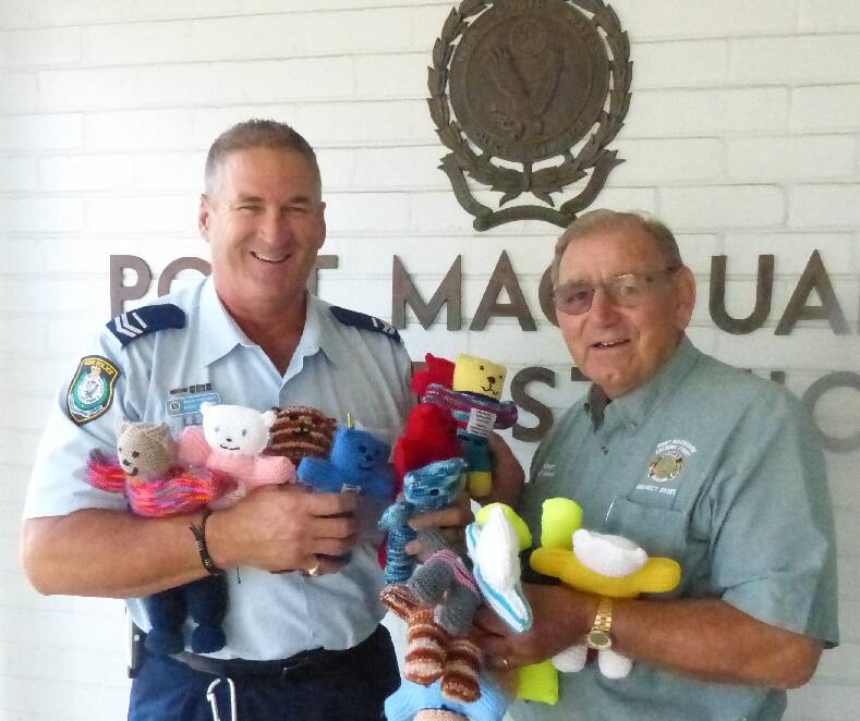 Welcome addition: Senior Constable Steve Cherry gratefully accepts some of the new trauma teddies from Lion Stuart Aston.