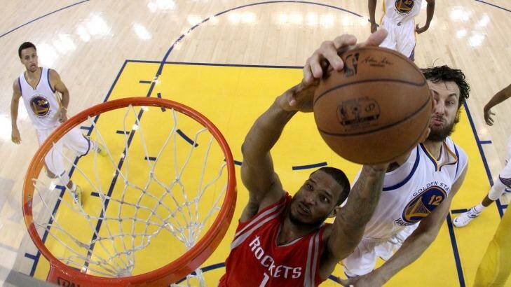 Denied: Boomers centre Andrew Bogut blocks Houston forward Trevor Ariza from behind during Golden State Warriors' game five win over the Rockets in Oakland. Photo: Ezra Shaw