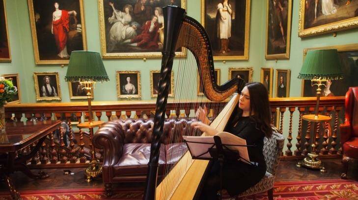 A harpist playing in the reception area of the Garrick Club. Photo: Supplied