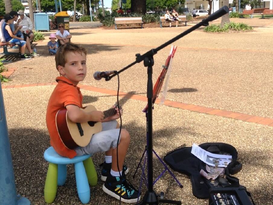 Young talent: Cameron Alford busks on the Town Green to help a sick Victorian boy travel to the FIFA World Cup.