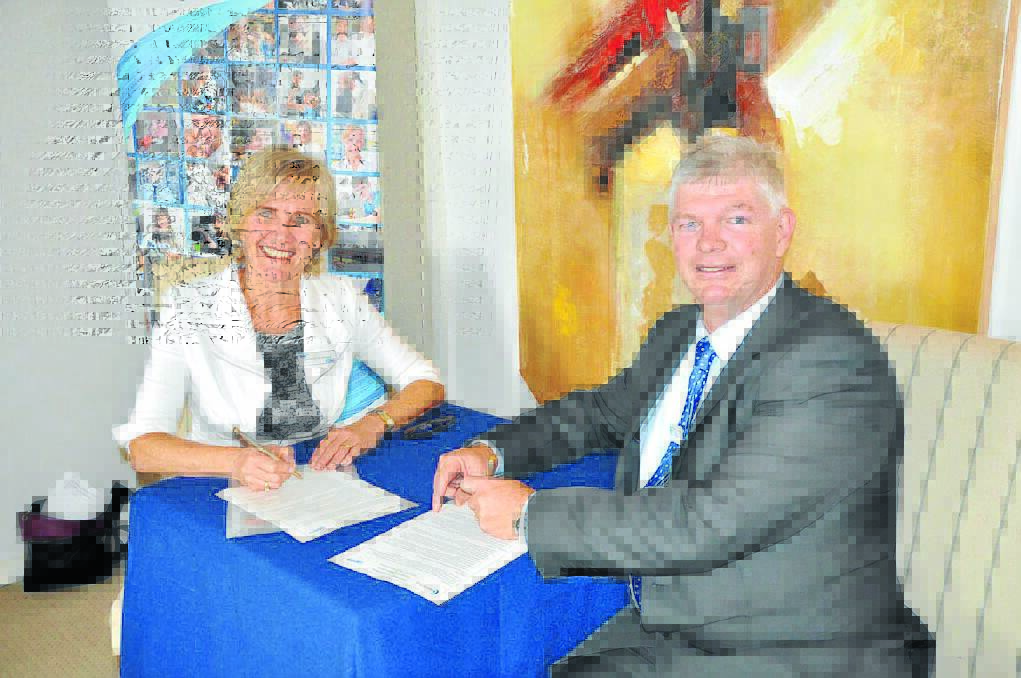 Shared benefits: North Coast TAFE director Elizabeth McGregor and Hastings Co-op CEO Allan Gordon sign the memorandum of understanding that 'cements the Co-op's commitment to life-long educational opportunities for all its employees'.