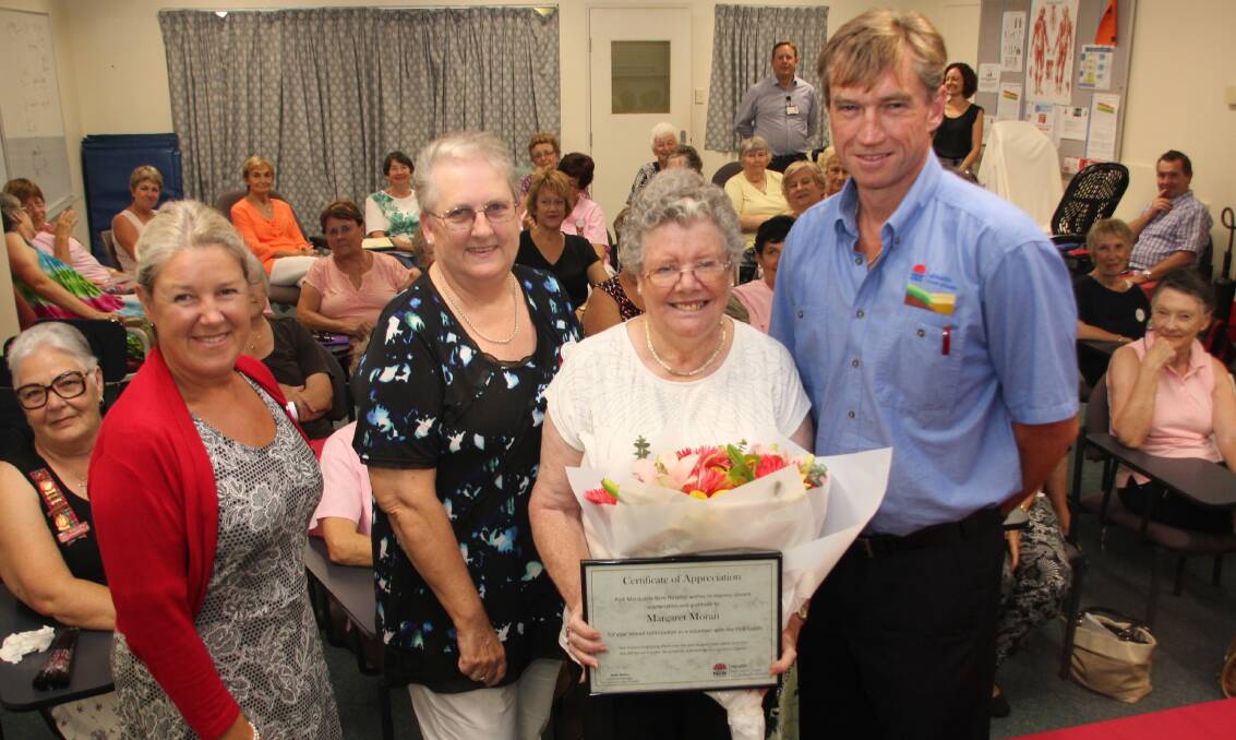 Great work:?Hospital volunteer Margaret Moran (second from right) with her certificate and flowers, which were presented at a special thank you function attended by (from left) Acting General Manager Jane Evans, Port Macquarie Pink Ladies president Gabby Gregory and MNCLHD chief executive Stewart Dowrick.