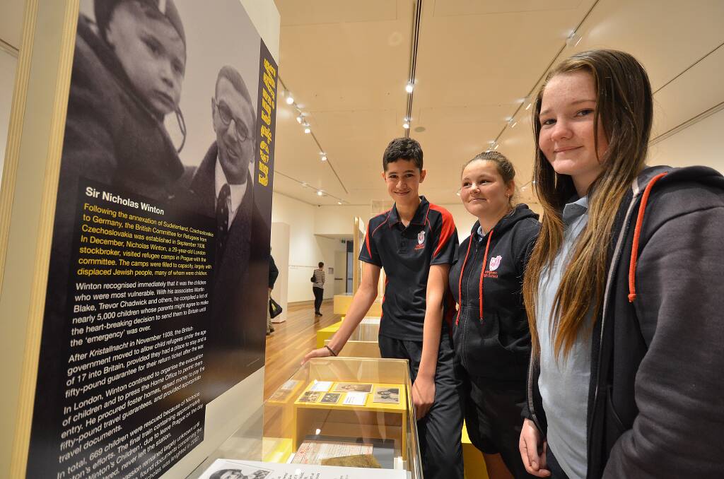 Making a difference: Maika Hull, Hannah Niksic and Emily Latimore from Wingham High at the Courage to Care exhibition at the Glasshouse Regional Gallery.