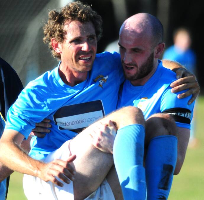 Assistance: Shaun Buckley is carried off by the Bodyguard , captain Nick Davies, on Saturday.