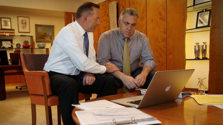 Prime Minister Tony Abbott poses with the Treasurer Joe Hockey as they look through Budget papers in Canberra on Tuesday. Photo: Andrew Meares