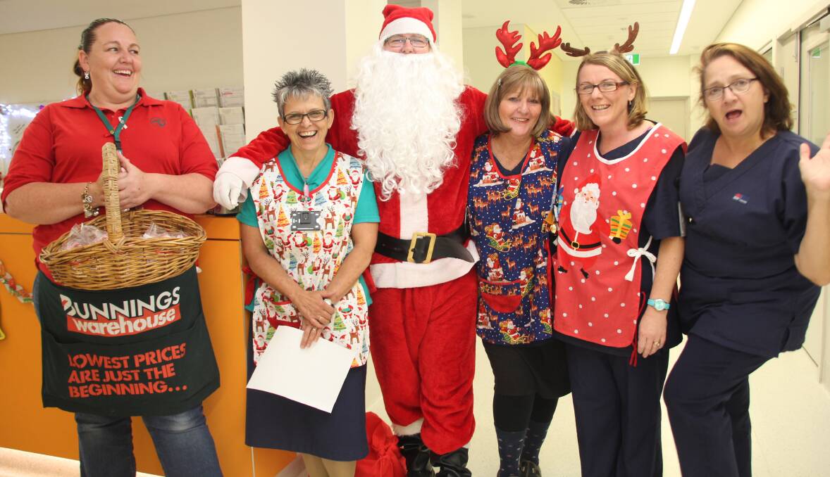 Helping hand: Bunnings' Activities Organiser Kylie Morrison and Santa with Paediatric Nurse Unit Manager Cheryl Nolte, and registered nurses Jill Nelis, Julie Edden and Lyndall Goetz.
