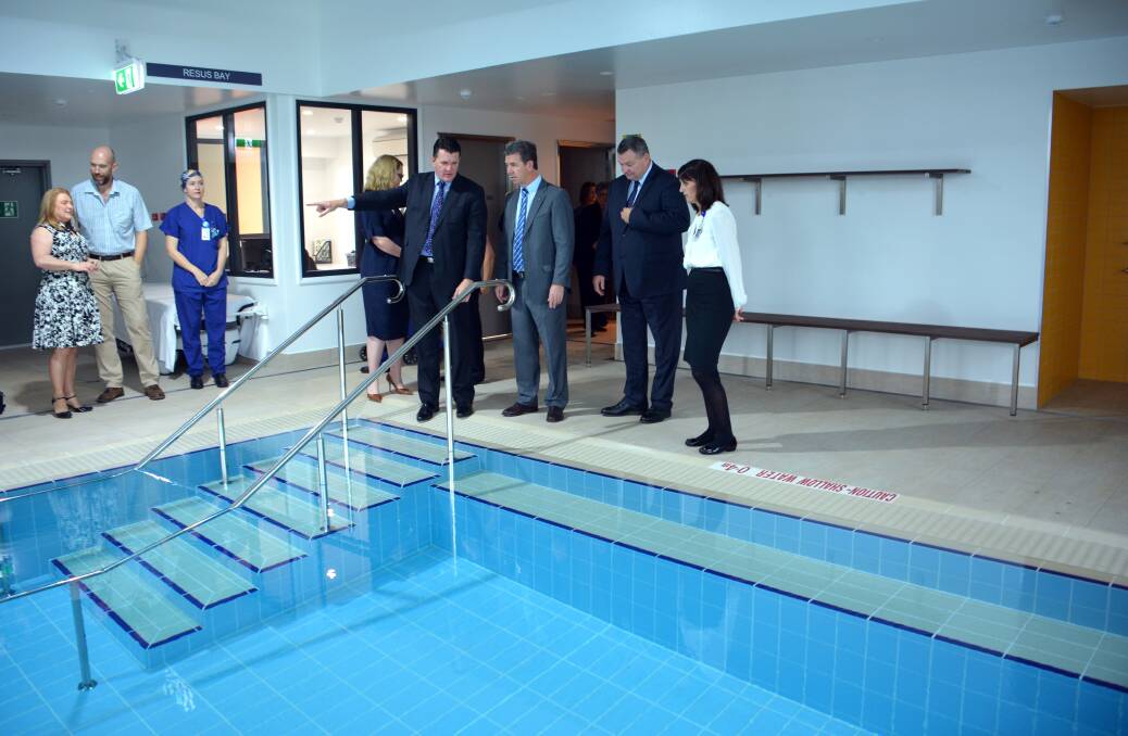 Guided tour: Port Macquarie Private Hospital chief executive officer Paul Geddes shows the hydrotherapy pool to Lyne MP Dr David Gillespie, Ramsay Health Care NSW regional operations manager Malcolm Passmore and acting director clinical services Jill McEvoy-Williams. Left, Official ceremony: Lyne MP Dr David Gillespie opens the Port Macquarie Private Hospital expanded rehabilitation unit as Port Macquarie Private Hospital chief executive officer Paul Geddes (left) and Ramsay Health Care NSW regional operations manager Malcolm Passmore look on.