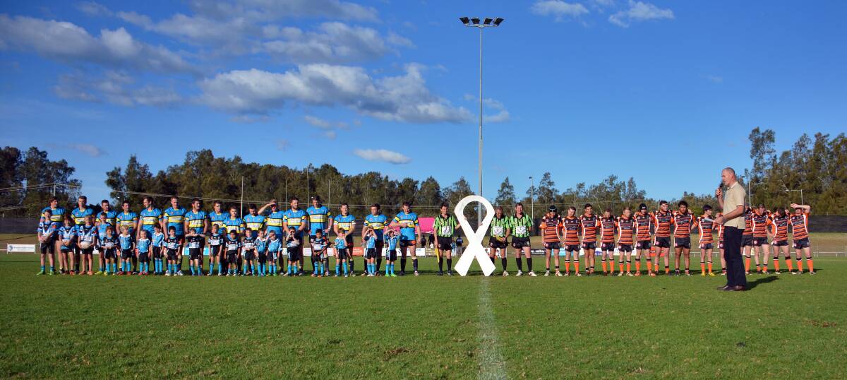 I swear : Junior and senior players from the Port Macquarie Sharks and Wingham Tigers stand for 16 seconds of silence and share the White Ribbon oath as a part of the inaugural White Ribbon Round to raise awareness about domestic violence.                                                                                                                                 Photo - MATT ATTARD