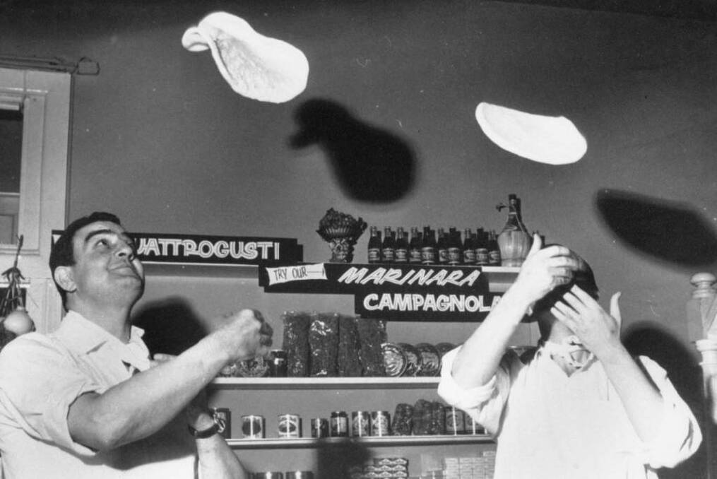 Salvatore Della Bruna (left) and Franco Fera making pizzas at Toto's Pizza House on Lygon Street Carlton in 1975. Photo: National Italian Musuem