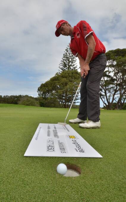 Maiden triumph: Port Macquarie golfer Andrew Kirkman had his first pro-am victory this week. He tries out the novelty cheque as a putting surface. 
Pic: NIGEL McNEIL