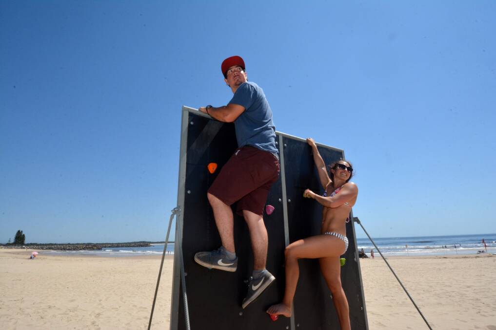Twenty obstacles to go: Isaac Morgan and Laura Dekker check out one of the obstacles competitors will face in tomorrow's Port Macquarie Sand Mudder along Town Beach.