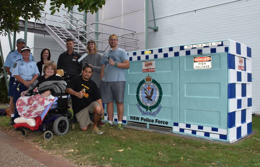 New look: Senior Constable Steve Cherry, Constable Wendy Hudson, community relations manager Rachel Hussell, House with No Steps area manager Peter Jenkins, RileyStringer, Jonathon Srbinovski with, in front: Cathryn Mitchell and Walter Hati.
