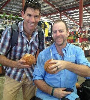 Immersed in culture: Garth Norris (left) and James Smith enjoy a 'niu' (coconut water) at the Fugalei Market in the Samoan capital, Apia.